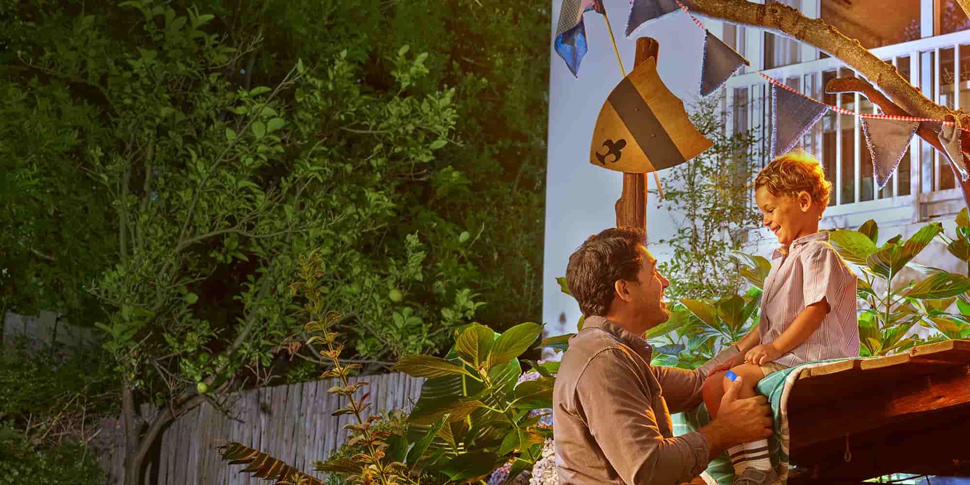 Dad and son hanging out at a tree house