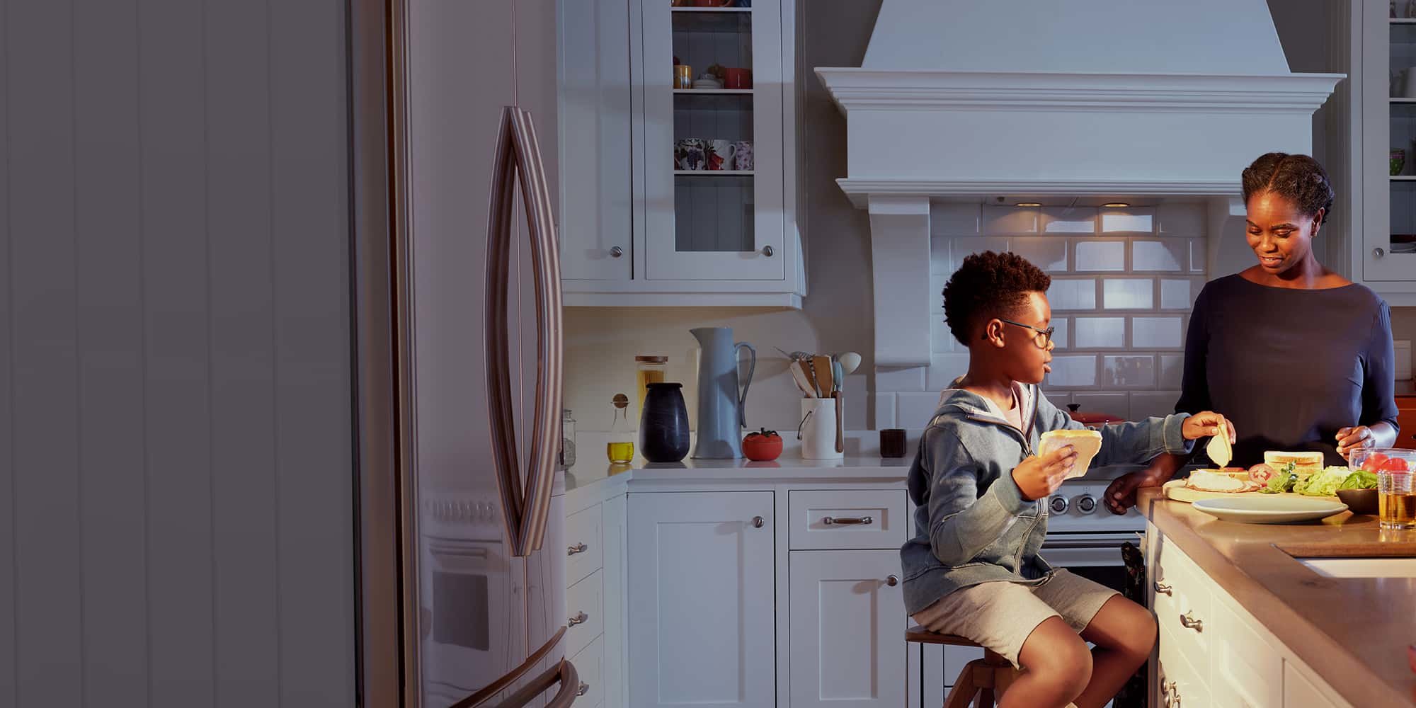 Mom and son making lunch in the kitchen.