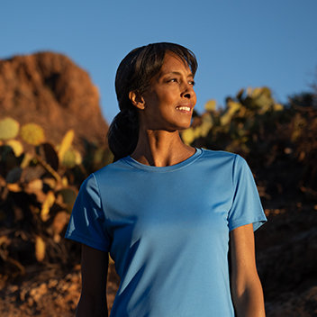 Woman in blue shirt looking out into the distance